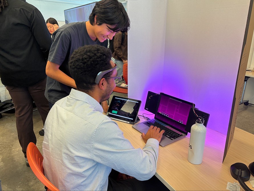 A visitor plays with the Muse 2 headband on while EEG streams to the tablet